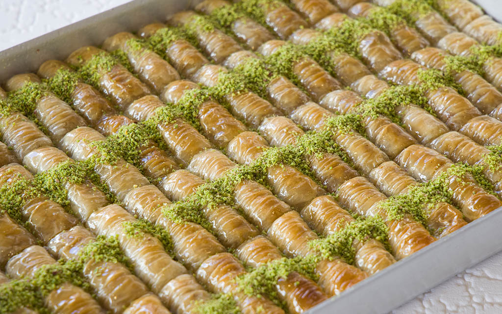 A box filled with dozens of Turkish baklava.