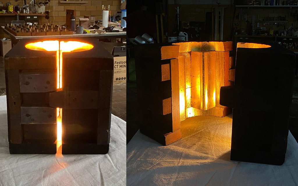 Two images of a foundry pattern. The inside of a hinged mold has been gilded and a light installed within it.