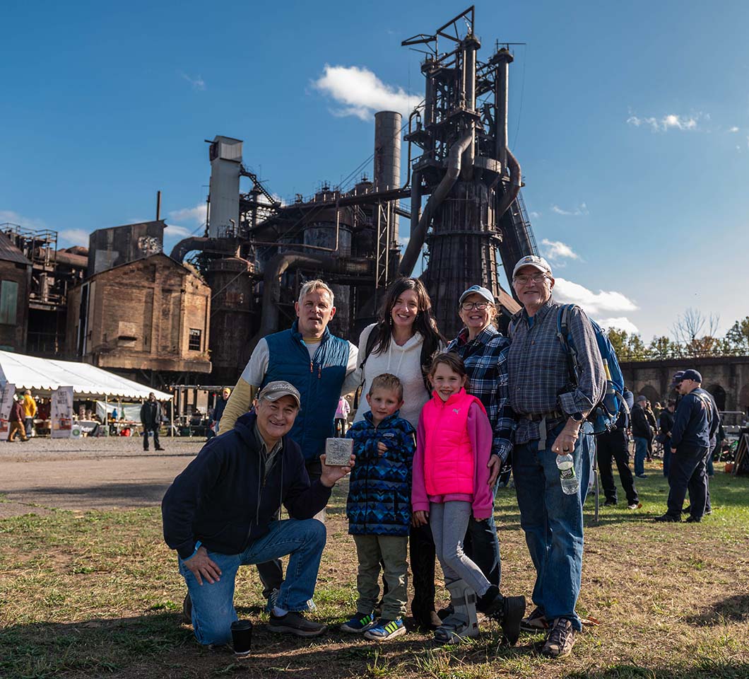 A multi-generational family poses in front of Furnace #7.