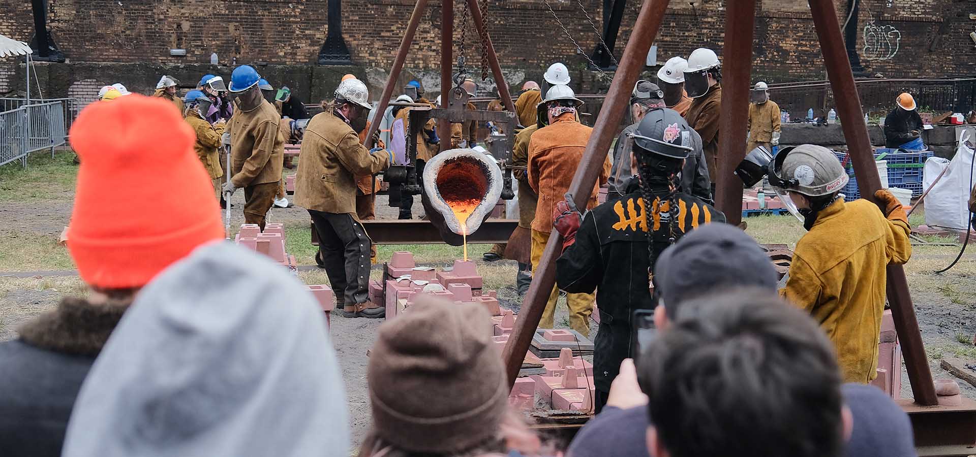 spectators watch an iron pour