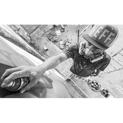 Artist Sef 1 works on a mural