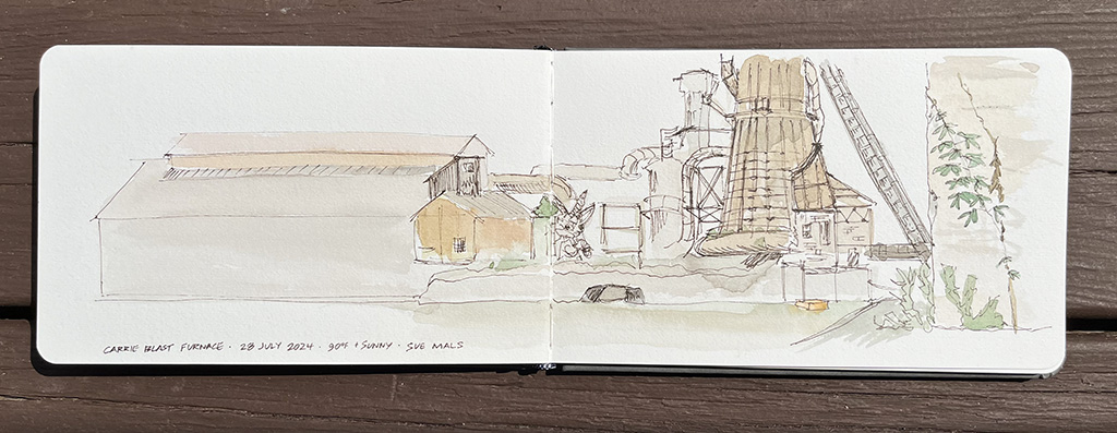 a landscape sketch in a small notebook spanning two pages of the furnace and surrounding buildings