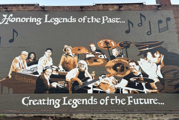 A mural of musicians painted on a wall.