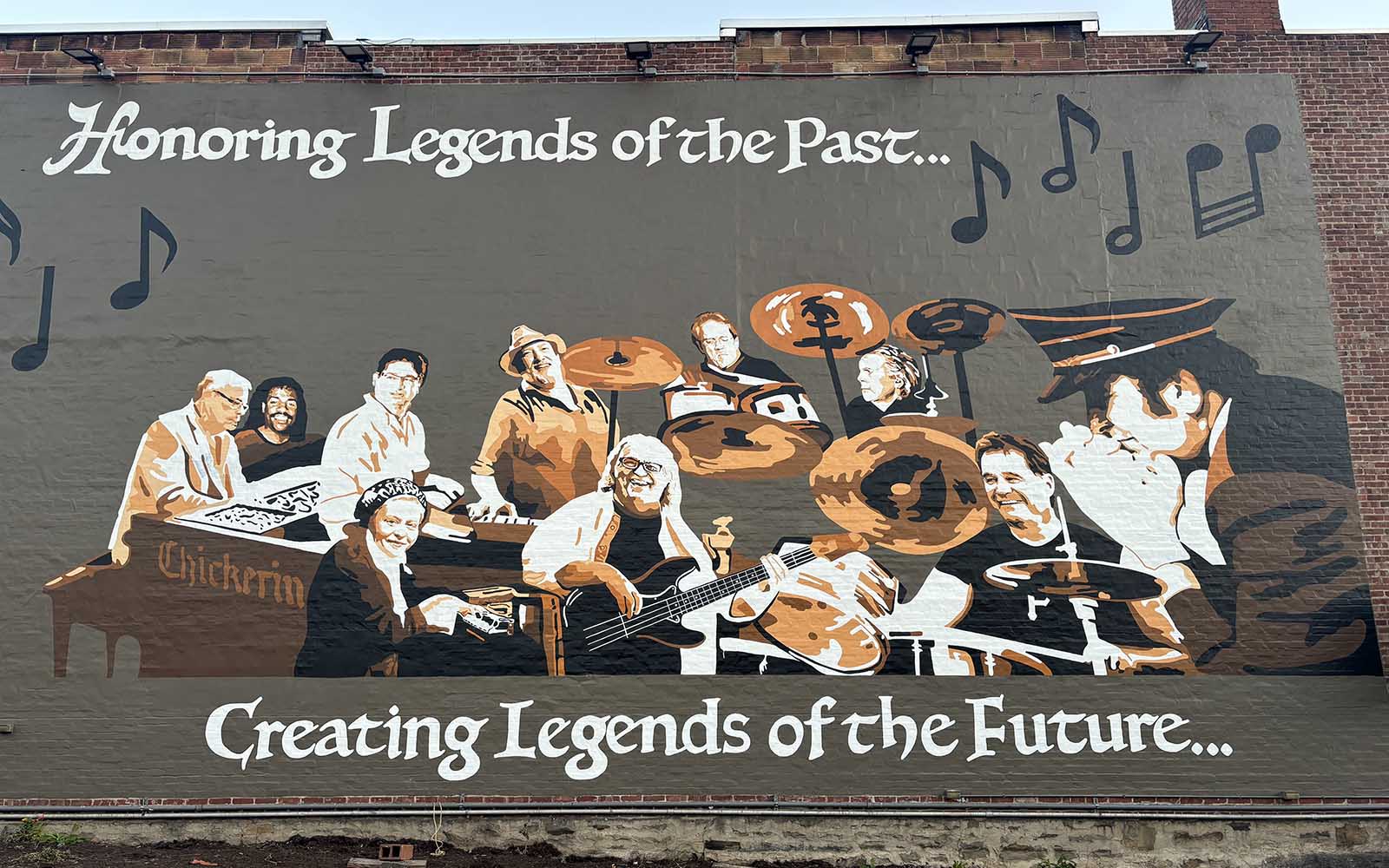 A mural of musicians painted on a wall.