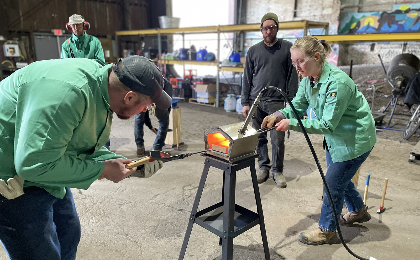 participants use a forge to heat their work