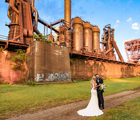 A bride and groom in the ore yard with the furnaces.