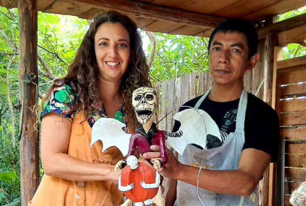 Artist Alison Zapata displays an artwork created with a workshop participant.