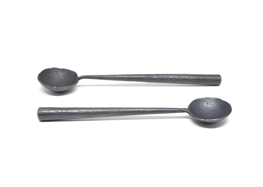 image of forged spoons on white background